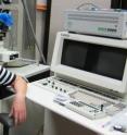 This is Liang Feng in front of a scanning electron microscope in the nanofabrication lab.