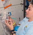 Nicole Stott, a flight engineer on Expedition 21 of the International Space Station, tests the quality of drinking water using chemistry and procedures developed by Iowa State University and Ames Laboratory researchers