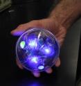 In the laboratory, a Sensorbot flashes out its code. By means of these brilliant blue pulses of light, the spherical undersea robot relays information about its environment. The light code is captured by high-speed cameras, which record and transmit the data for later analysis.