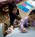 Michigan State University researcher Desiree Baolian Qin works with daughters Olivia, 4, and Helena, 2.  Qin refutes the "tiger mother" philosophy that parents should drive their children to succeed even at the expense of the kids' happiness.
