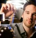 Wake Forest graduate student Corey Hewitt holds a piece of Power Felt developed in the Center for Nanotechnology and Molecular Materials.