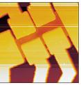 An image of a suspended graphene device made by a scanning probe microscope. The graphene sheet is the orange-colored layer suspended between six rectangular columns made of silicon dioxide and capped by gold.