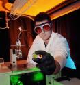 Georgia Tech graduate student Brandon Polander prepares for his FT-IR experiment. The green laser light is used to photo excite the spinach photosytem II sample.