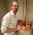 Dartmouth research associate Joshua Landis prepares to introduce a radioactive sample into a gamma-ray spectrometer.