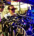 Georgia Tech graduate student Yaroslav Dudin and professor Alex Kuzmich adjust optics as part of research into the production of single photons for use in optical quantum information processing and the study of certain physical systems.