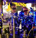 Georgia Tech graduate student Yaroslav Dudin and professor Alex Kuzmich (adjust optics as part of research into the production of single photons for use in optical quantum information processing and the study of certain physical systems.