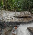 This is a view of a Maya-built canal. Pictured is Guatemalan researcher Liwy Grazioso, who has participated in the work by a UC-led team.