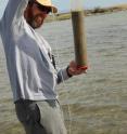 Mitchell Power, of the University of Utah and Natural History Museum of Utah, pulls a sediment core out of Spring Lake near Delta, Utah. The sediment core showed a reduction in charcoal – and thus fire – in the area during the Little Ice Age, a time of global cooling that began sometime between that A.D. 1200s and 1500s and ended in the early 1800s. A new study led by Powers suggests the Little Ice Age led to a worldwide reduction in fires after 1500, and that reduction was not caused by decimation of New Word populations by European diseases in the wake of Columbus.