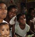 Basanti, left, shown here with children in her family, survived a witch hunt in India's tea plantations.