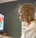 A BYU student wears an EEG recording device to demonstrate how researchers measured neural responses to food after exercise.