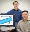 Xiang Zhang (seated) and Tongcang Li have proposed a way to make a four-dimensional space-time crystal, a device that could be used to study the many-body problem of physics and other quantum phenomena.