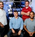 Illinois researchers -- from left, graduate student Amir Arbabi, professor Gabriel Popescu, graduate student Chris Edwards and professor Lynford Goddard -- use a special microscope to simultaneously etch tiny features in semiconductor wafers and monitor the process in real time.