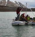 From a coring platform perched atop two inflatable rafts, scientists in Svalbard can raise sediment cores from the lakebed below.