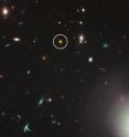 This is a Hubble Space Telescope view of one of the most distant and luminous quasars ever seen (circled in white) and dates to less than one billion years after the big bang. This near-infrared light image was taken with Hubble's Wide Field Camera 3 in December 2010 and January 2011.