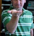 This shows University of Adelaide researcher Dr. Steven Wiederman with a dragonfly in the Adelaide Centre for Neuroscience Research.