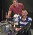 This shows University of Adelaide researchers (from left) Associate Professor David O'Carroll and Dr. Steven Wiederman with a dragonfly under the microscope in the Adelaide Centre for Neuroscience Research.