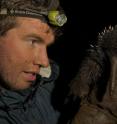 Scientist Kristofer Helgen, Smithsonian Institution, examines a long-beaked echidna in the wild on the island of New Guinea, where a small and declining population of the species is still known to exist.