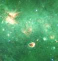 Researchers have identified the first "bone" of the Milky Way - a long tendril of dust and gas that appears dark in this infrared image from the Spitzer Space Telescope. Running horizontally along this image, the
"bone" is more than 300 light-years long but only 1 or 2 light-years wide.
It contains about 100,000 suns' worth of material.