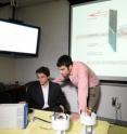 Georgia Tech associate professor Gleb Yushin (left) and graduate research assistant Sofiane Boukhalfa examine experimental results from their study of the adsorption of ions.