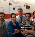 This image shows the University of Washington Department of Microbiology team for the <i>Nature</i> paper, "Accelerated gene evolution through replication-transcription conflicts," in front of a microbiology history timeline: Sandip Paul, Houra Merrikh, Evgeni Sokurenko, Sujay Chattopadhyay, and Samuel Million-Weaver.