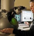 Deborah Kelly, an assistant professor at the Virginia Tech Carilion Research Institute, works with a system that enables researchers to watch the behaviors of therapeutic nanoparticles at atomic resolution.