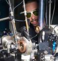 This image shows the experimental set-up of the experiment at ESRF beamline ID27 where the diffraction maps were recorded. The diamond anvil cell is inside the brass cylinder in the center. The image pictures Guillaume Morard, one of the co-authors of the publication, wearing laser safety goggles.