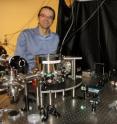 A new window into the nature of the universe may be possible with a device proposed by scientists at the University of Nevada, Reno and Stanford University that would detect elusive gravity waves from the other end of the cosmos. Their paper describing the device and process was published in the prestigious physics journal <i>Physical Review Letters</i>. Andrew Geraci, assistant professor in the University of Nevada, Reno physics department, demonstrates an apparatus that is of part of an experiment that uses similar technology to his gravitational wave detector. This equipment uses levitated nanospheres in an optical trap for investigations of the gravitational force at the micron length scale, where some theories in high-energy physics predicts there will be a deviation from the Newtonian inverse square law of gravitation.