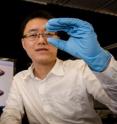 This is NTU Asst Prof Wang Qijie looking through the mono-layered nanostructured graphene which his team had designed.