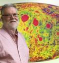 Jay Melosh, a Purdue distinguished professor of Earth, atmospheric and planetary sciences, stands in front of a map showing the moon's gravity field. As a member of the science team of NASA's Gravity Recovery and Interior Laboratory, or GRAIL, mission, Melosh led a study of large concentrations of mass beneath the lunar surface. The team confirmed that the mass concentrations, or "mascons," were caused by massive asteroid impacts billions of year ago and determined how these impacts changed the density of material on the moon's surface and, in turn, its gravity field.