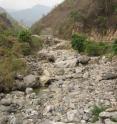 This tributary of the Nu River in China has lost its water flow below a dam.