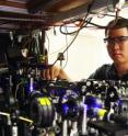 Georgia Tech graduate student Lin Li adjusts the optics on equipment being used to measure the entanglement between light and an optical atomic excitation in the laboratory of Alex Kuzmich.