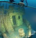 Lionfish are visible near the door of this sunken ship off the Florida coast.
