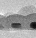 This is a cross-section of the record-thin absorber layer showing three gold nanodots, each about 14x17 nanometers in size and coated with tin sulfide.