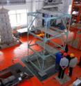 Earthquake-engineering researchers at the Harbin Institute of Technology in China work to set up a structure on a shake table for experiments to study the effects of earthquakes. Purdue University civil engineering students are working  with counterparts at the institute to study the reliability of models for testing a type of powerful damping system that might be installed in buildings and bridges to reduce structural damage and injuries during earthquakes.