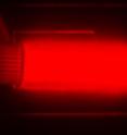 This image shows bright light emission from silicon quantum dots in a cuvette. The image is from a camera that captures the near-infrared light that the quantum dots emit. The light emission shown is a pseudo color, as near-infrared light does not fall in the visible spectrum.