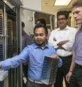 From left, Soca Wibowo, Mirage Singh and Charles Dann III examine a slide tray at IU Bloomington's Crystallization Automation Facility.