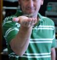 This is University of Adelaide researcher Dr Steven Wiederman with a dragonfly in the Adelaide Centre for Neuroscience Research.