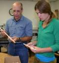 US Forest Service scientist Paul Schaberg, left, and Alexandra Kosiba of the University of Vermont examine tree cores. In the course of research on red spruce and carbon storage, Schaberg, Kosiba and colleagues from the University of Vermont found an unexpected rebound in red spruce growth.