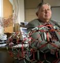 Harry Dorn, a professor at the Virginia Tech Carilion Research Institute, poses with models of "buckyballs." His research supports the theory that a soccer ball-shaped nanoparticle commonly called a buckyball is the result of a breakdown of larger structures rather than being built atom-by-atom from the ground up.