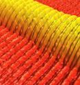 This atomic force microscope image shows directed self-assembly of a printed line of block copolymer on a template prepared by photolithography. The image was colored and scaled by the microscope's software. The density of patterns in the template (bounded by the thin lines) is two times that of the self-assembled structures (the ribbons).
