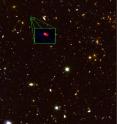 This image from the Hubble Space Telescope CANDELS survey highlights the most distant galaxy in the universe with a measured distance, dubbed z8-GND-5296. The galaxy's red color alerted astronomers that it was likely extremely far away, and thus seen at an early time after the Big Bang. The magnified image results from stacks of optical and infrared images taken, respectively, by the Advanced Camera for Survey (ACS) and Wide-Field Camera 3 (WFC3) on board the Hubble. The galaxy has a mass of ~10<sup>9</sup> times the mass of the Sun and is at a distance of ~13 billion light years from us, forming stars nearly 150 times more rapidly than our galaxy.