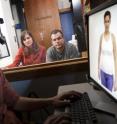 Sarah J. Gervais, Assistant Professor of Psychology and Women's Studies and Mike Dodd, Associate Professor of Psychology, watch as graduate student Gerald McDonnell demonstrates the eye track hardware and software used for the research (Sept. 24, 2013).
