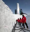 Members of the IceCube Collaboration pull cables to connect light sensors deployed in subsurface ice to the IceCube Lab's servers in Dec. 2010. The work was carried out at temperatures as low as -25 degrees Fahrenheit.