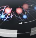 This is an artist's conception of JILA's new technique for measuring the electron's roundness, or electric dipole moment (EDM). The method involves trapping molecular ions of hafnium fluoride (red and blue spheres, respectively) in spinning electric and magnetic fields. Researchers measure changes over time in the "spin" direction of the molecules' unpaired electrons (arrows in yellow spheres), which act like tiny bar magnets. Specific patterns in the rate of change, reflecting alterations in the gap between two magnetic energy levels in the molecules, would indicate the existence and size of an EDM. This is an artist's conception of JILA's new technique for measuring the electron's roundness, or electric dipole moment (EDM). The method involves trapping molecular ions of hafnium fluoride (red and blue spheres, respectively) in spinning electric and magnetic fields. Researchers measure changes over time in the "spin" direction of the molecules' unpaired electrons (arrows in yellow spheres), which act like tiny bar magnets. Specific patterns in the rate of change, reflecting alterations in the gap between two magnetic energy levels in the molecules, would indicate the existence and size of an EDM.