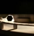 This is a copper-oxide superconducting pellet levitating over a magnetic track.