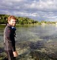 Douglas Rasher, who studied chemical warfare on coral reefs as part of his Ph.D. dissertation at Georgia Tech, heads out on the reef to monitor an experiment.