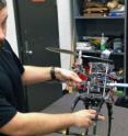 UC student Bryan Brown displays a quadrotor UAV.