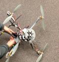 University of Cincinnati student Wei Wei makes adjustments to a UAV.
