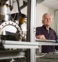 Walt de Heer, a Regent's professor in the School of Physics at the Georgia Institute of Technology, poses with equipment used to measure the properties of graphene nanoribbons. De Heer and collaborators from three other institutions have reported ballistic transport properties in graphene nanoribbons that are about 40 nanometers wide.