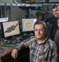 Researchers are shown testing a single-chip catheter-based device that would provide forward-looking, real-time, three-dimensional imaging from inside the heart, coronary arteries and peripheral blood vessels. Shown (left-to-right) are postdoctoral fellow Coskun Tekes, Ph.D. student Toby Xu and professor F. Levent Degertekin.